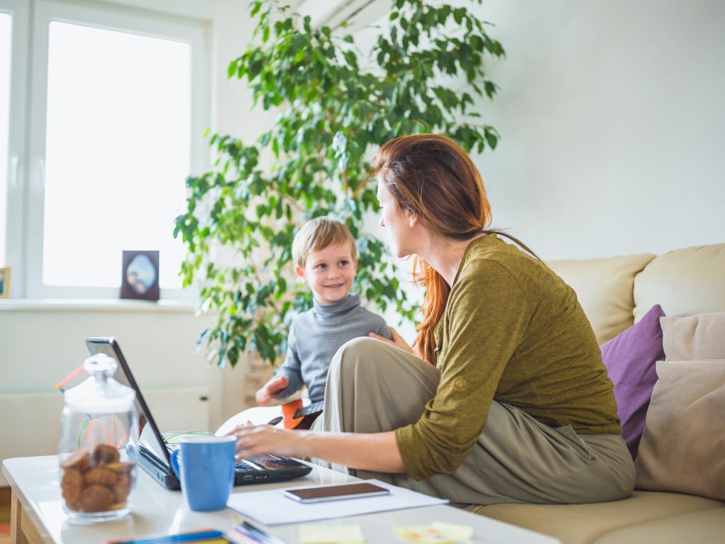 Person and child on couch with laptop L